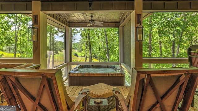 sunroom featuring a hot tub and a ceiling fan