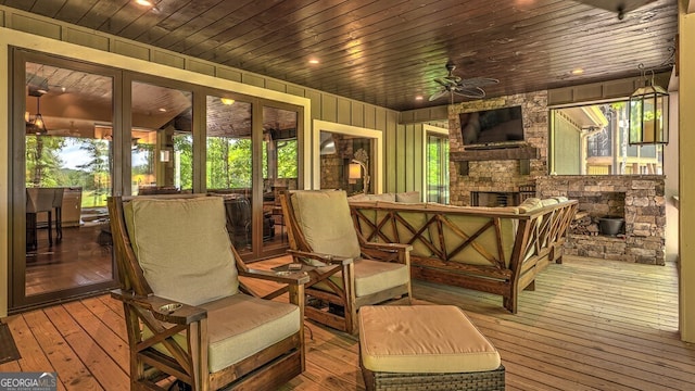 deck with an outdoor living space with a fireplace, french doors, and ceiling fan