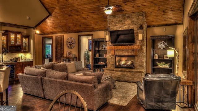 living room featuring a ceiling fan, wine cooler, a stone fireplace, wood ceiling, and wet bar