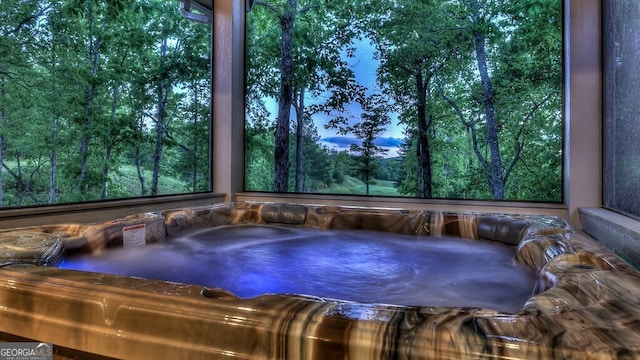 exterior space with an outdoor hot tub