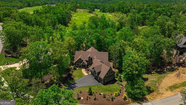 drone / aerial view featuring a wooded view