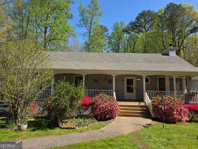 1180 Edwards Mill Rd, Ball Ground, GA 30107 - ranch-style home featuring a chimney, a front yard, and a porch