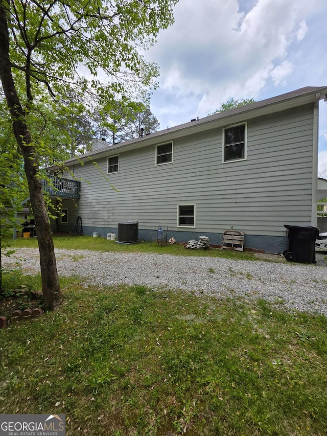 1180 Edwards Mill Rd, Ball Ground, GA 30107 - back of property with central air condition unit and a lawn