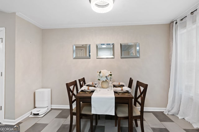 dining room featuring crown molding, baseboards, and tile patterned floors