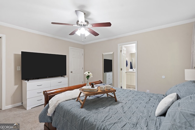 bedroom with a ceiling fan, crown molding, ensuite bathroom, baseboards, and light carpet