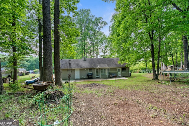 4355 Saddlewood Ct, Gillsville, GA 30543 - back of property with a patio area and dirt driveway