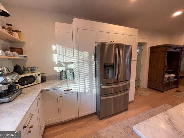 185 A W Roberts Dr, Ball Ground, GA 30107 - kitchen featuring stainless steel fridge with ice dispenser, white cabinetry, open shelves, recessed lighting, and light stone countertops