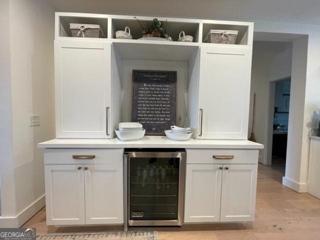 185 A W Roberts Dr, Ball Ground, GA 30107 - bar with wine cooler, baseboards, and light wood-style floors