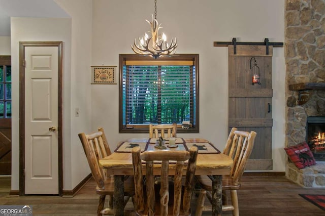 200 Villa Rd Unit 128, Jasper, GA 30143 - dining space with a chandelier, wood finished floors, a barn door, and a fireplace