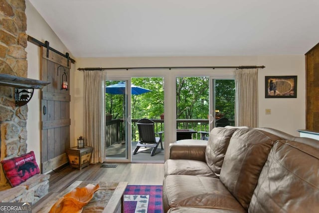 200 Villa Rd Unit 128, Jasper, GA 30143 - living area featuring wood finished floors, a barn door, and lofted ceiling