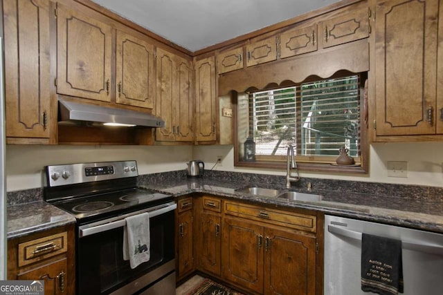 200 Villa Rd Unit 128, Jasper, GA 30143 - kitchen featuring appliances with stainless steel finishes, under cabinet range hood, dark stone countertops, and brown cabinetry