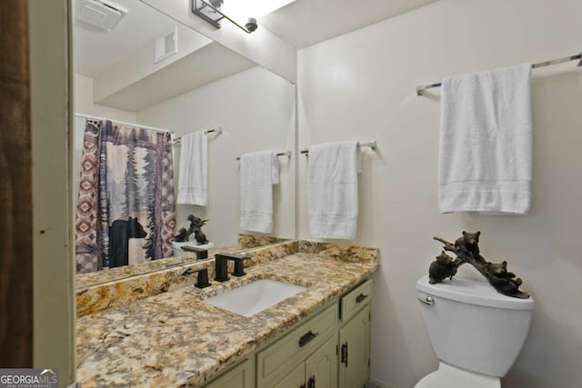 full bath featuring toilet, visible vents, and vanity