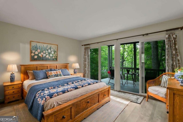 bedroom featuring light wood-type flooring and access to outside