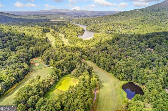 aerial view with a water and mountain view, a wooded view, and golf course view