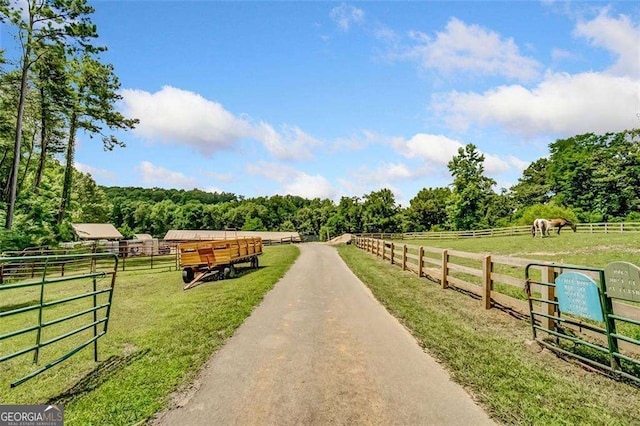 view of street featuring a rural view and an exterior structure