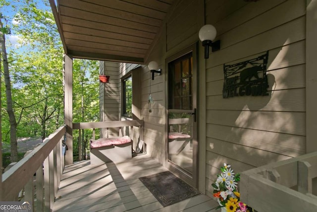 wooden terrace featuring covered porch