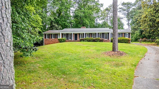 3916 Ridgewood Dr SE, Smyrna, GA 30080 - single story home featuring brick siding, a front lawn, a chimney, and driveway