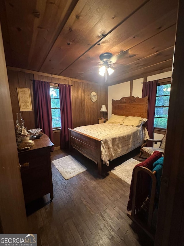 bedroom with multiple windows, wood ceiling, and dark wood-type flooring