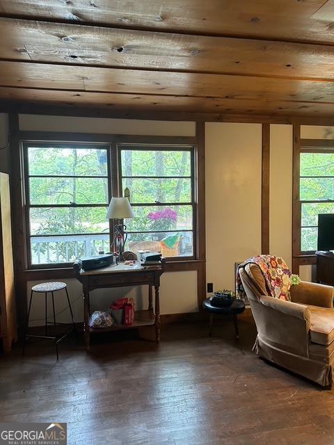 sitting room with wooden ceiling and hardwood / wood-style flooring