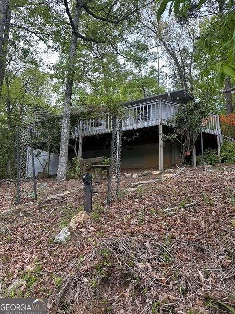 view of yard featuring a wooden deck and fence