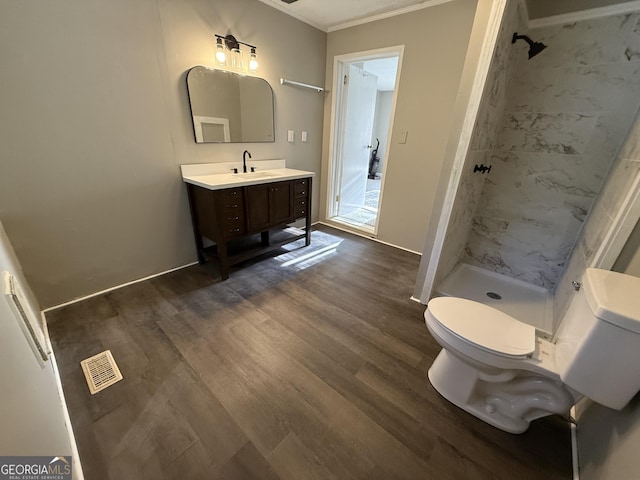 1057 Clay Ave, Macon, GA 31211 - full bath featuring ornamental molding, toilet, wood finished floors, and a tile shower