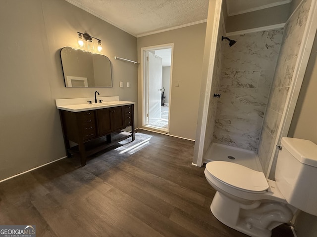 1057 Clay Ave, Macon, GA 31211 - bathroom with crown molding, a stall shower, vanity, wood finished floors, and a textured ceiling