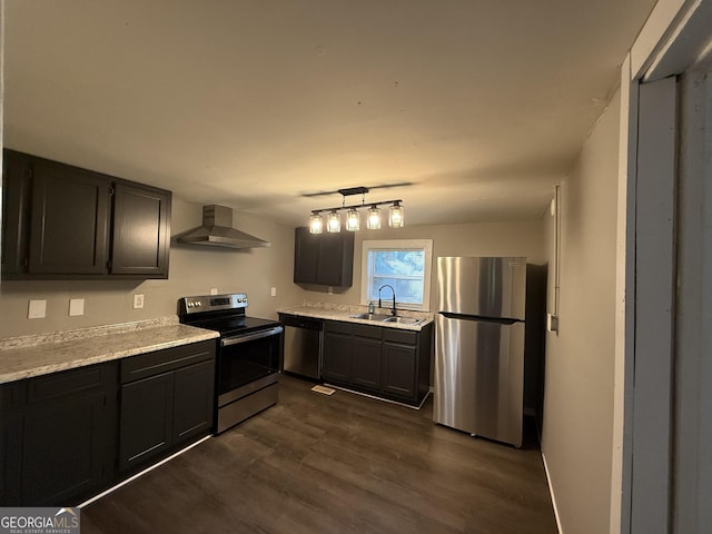 1057 Clay Ave, Macon, GA 31211 - kitchen with a sink, stainless steel appliances, wall chimney exhaust hood, light countertops, and dark wood-style floors