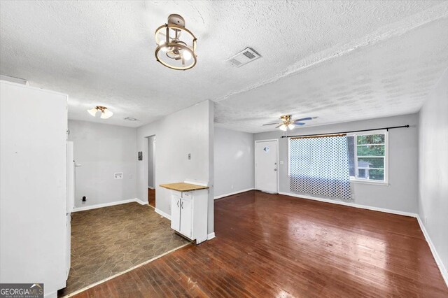 844 Oak St NW, Atlanta, GA 30318 - spare room with a textured ceiling, baseboards, visible vents, ceiling fan with notable chandelier, and hardwood / wood-style floors
