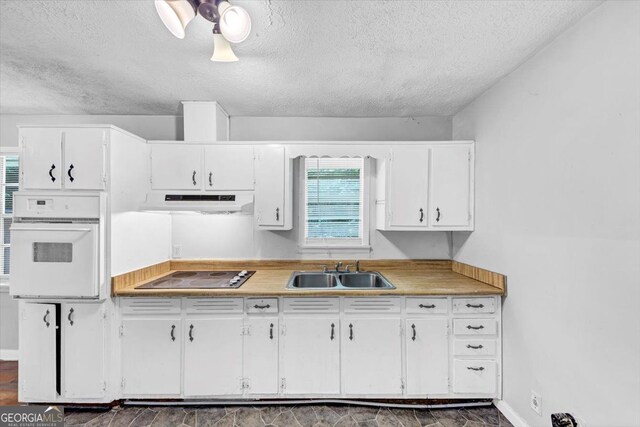 844 Oak St NW, Atlanta, GA 30318 - kitchen with a textured ceiling, black electric cooktop, a sink, and white oven