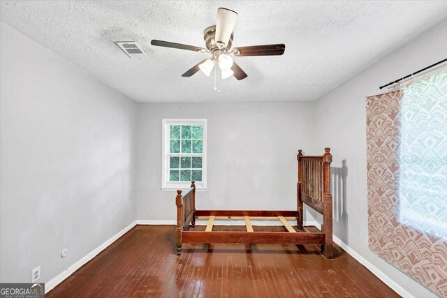 844 Oak St NW, Atlanta, GA 30318 - bedroom with a textured ceiling, visible vents, baseboards, and hardwood / wood-style flooring