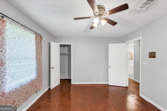 844 Oak St NW, Atlanta, GA 30318 - unfurnished bedroom with a textured ceiling, visible vents, baseboards, ceiling fan, and hardwood / wood-style flooring
