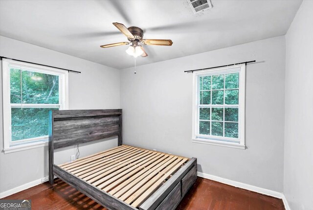 844 Oak St NW, Atlanta, GA 30318 - unfurnished bedroom featuring baseboards, a ceiling fan, visible vents, and wood finished floors