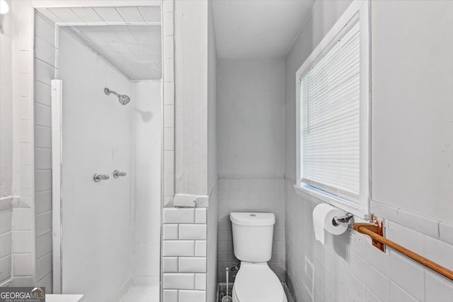 844 Oak St NW, Atlanta, GA 30318 - bathroom with toilet, tile walls, a wainscoted wall, and a walk in shower