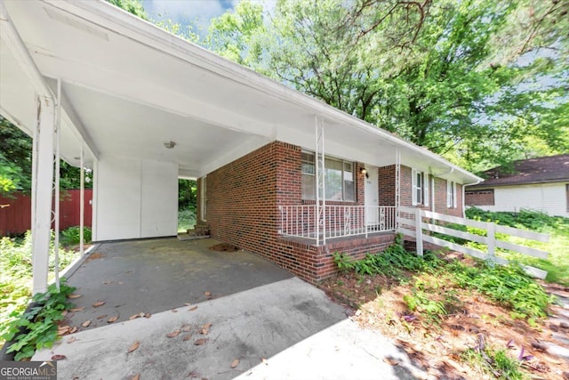 844 Oak St NW, Atlanta, GA 30318 - ranch-style house with driveway, an attached carport, brick siding, and fence