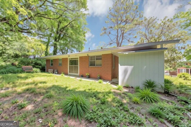 844 Oak St NW, Atlanta, GA 30318 - back of house with brick siding and a lawn