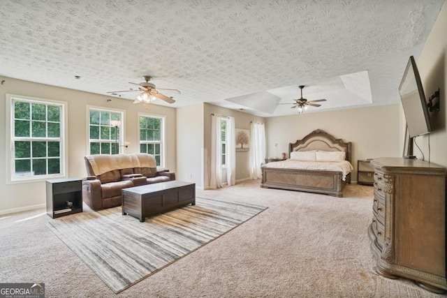 1314 Durham Ter, Mcdonough, GA 30252 - bedroom with light colored carpet, a tray ceiling, and a ceiling fan