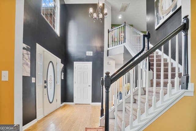 1314 Durham Ter, Mcdonough, GA 30252 - entrance foyer featuring a towering ceiling, wood finished floors, stairs, and a chandelier