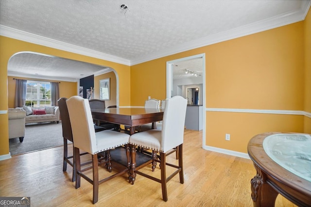 1314 Durham Ter, Mcdonough, GA 30252 - dining room featuring arched walkways, light wood-type flooring, and crown molding