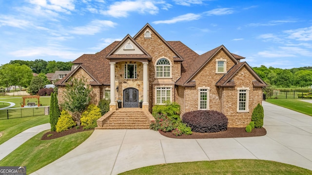 770 Tralee Dr, Fayetteville, GA 30215 - view of front of house featuring brick siding, french doors, a front lawn, and fence