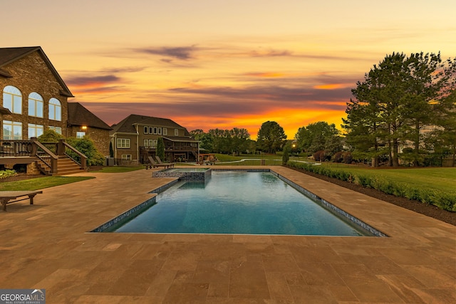 770 Tralee Dr, Fayetteville, GA 30215 - pool at dusk with a yard, a pool with connected hot tub, stairs, a patio area, and a wooden deck