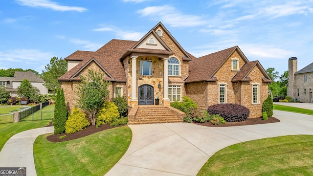 770 Tralee Dr, Fayetteville, GA 30215 - view of front of house with fence, a shingled roof, a front lawn, and brick siding