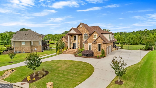 770 Tralee Dr, Fayetteville, GA 30215 - view of front facade featuring concrete driveway, fence, a front lawn, and stone siding