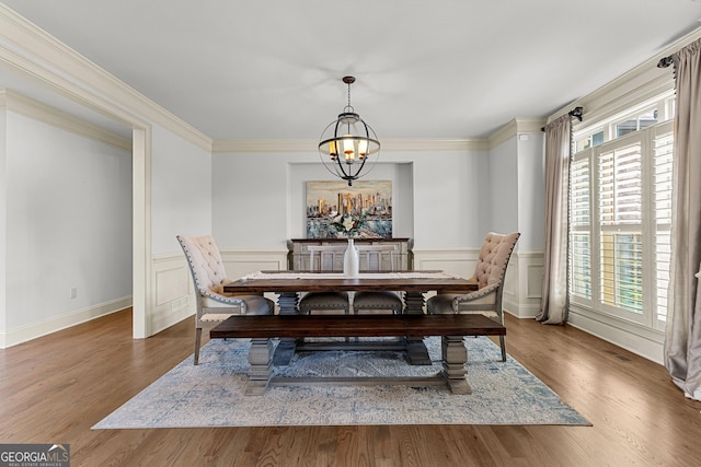 770 Tralee Dr, Fayetteville, GA 30215 - dining space with crown molding, a notable chandelier, a wainscoted wall, and wood finished floors