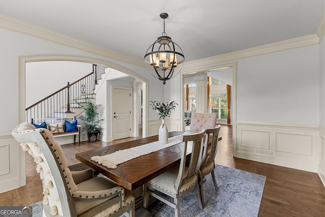 770 Tralee Dr, Fayetteville, GA 30215 - dining area with a notable chandelier, wainscoting, stairs, a decorative wall, and crown molding