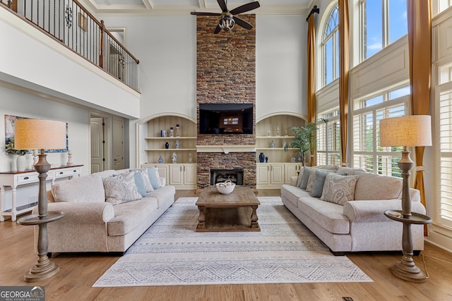 770 Tralee Dr, Fayetteville, GA 30215 - living area featuring ornamental molding, a stone fireplace, a ceiling fan, and a high ceiling