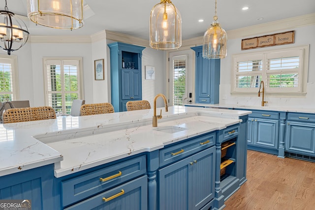 770 Tralee Dr, Fayetteville, GA 30215 - kitchen featuring a sink, blue cabinets, a chandelier, and light wood-style floors