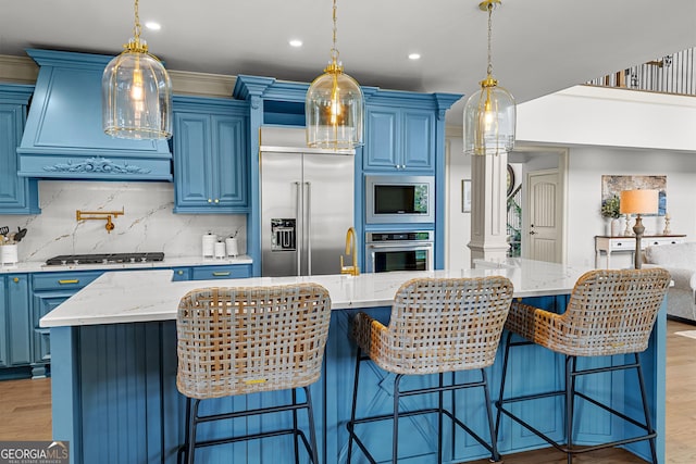 770 Tralee Dr, Fayetteville, GA 30215 - kitchen featuring light wood-type flooring, built in appliances, a large island, blue cabinets, and custom exhaust hood
