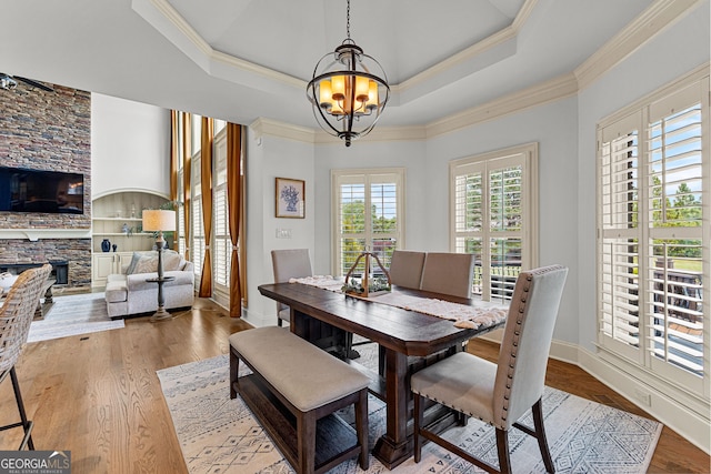 770 Tralee Dr, Fayetteville, GA 30215 - dining area with ornamental molding, a chandelier, wood finished floors, and a stone fireplace