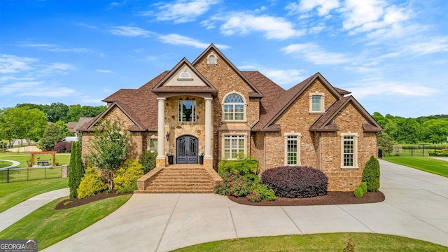 770 Tralee Dr, Fayetteville, GA 30215 - view of front of home with brick siding, fence, and a front yard