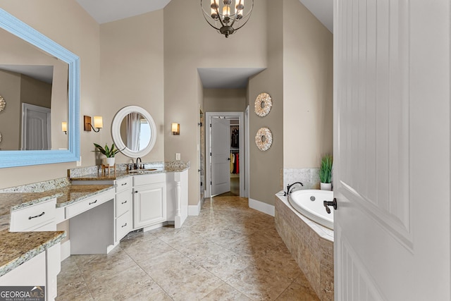 770 Tralee Dr, Fayetteville, GA 30215 - full bathroom with tile patterned floors, a garden tub, vanity, a towering ceiling, and a walk in closet